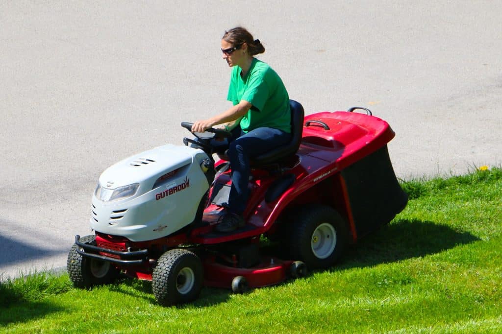 Woman driving a lawn mower